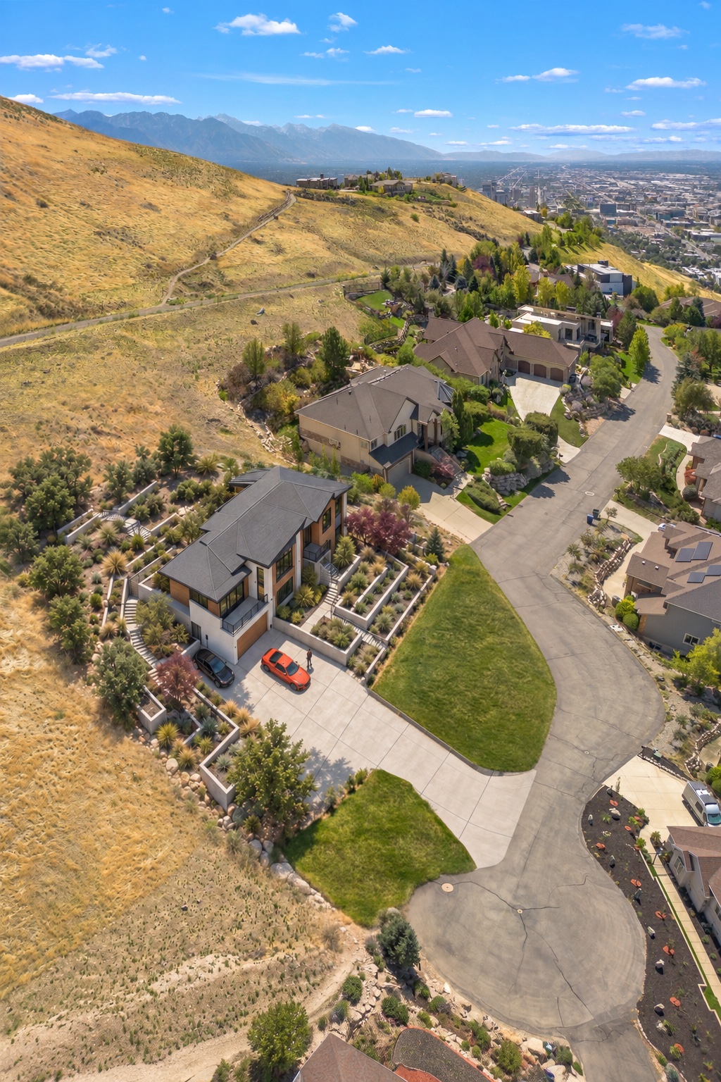 Conceptual aerial visualization of the proposed residence set against the actual hillside and Salt Lake Valley backdrop